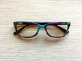 Multicolored glasses on a wooden table