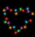 Multicolored glassy lights like heart frame isolated on black