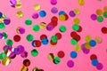 Multicolored glitter on pink background