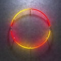 Multicolored glowing neon circle on a concrete background. Semicircular neon light tubes red to yellow glow. 3d illustration Royalty Free Stock Photo