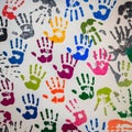 Multicolored handprints scattered across a white surface, reflecting creativity and community