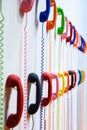 Multicolored handsets with spring wire spiralon a white wall. Royalty Free Stock Photo