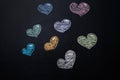 Multicolored hearts drawn in chalk on black chalkboard