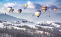 Multicolored hot air balloons on a mountains covered snow Royalty Free Stock Photo