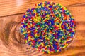 Multicolored hydrogel balls in a glass bowl on wooden table. Top view Royalty Free Stock Photo