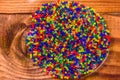 Multicolored hydrogel balls in a glass bowl on wooden table. Top view Royalty Free Stock Photo