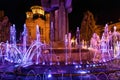 Multicolored illuminated fountain around the statue of Avram Iancu, located in Cluj-Napoca, Romania