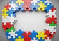 Multicolored jigsaw puzzle pieces form a circular frame. The Royalty Free Stock Photo