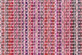 Multicolored knitted fabric background texture. ÃÂ¡olorful red fabric with a pattern. Fragment colored wool carpet, bright wicker Royalty Free Stock Photo