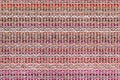 Multicolored knitted fabric background texture. ÃÂ¡olorful red fabric with a pattern. Fragment colored wool carpet, bright wicker Royalty Free Stock Photo
