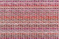 Multicolored knitted fabric background texture. ÃÂ¡olorful red fabric with a pattern. Fragment colored wool carpet, bright wicker Royalty Free Stock Photo