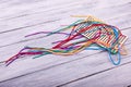 Multicolored laces for playing on the light wooden background. Royalty Free Stock Photo