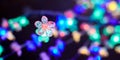 Multicolored lights bokeh from decorative luminous flowers garlands at holiday, multicolored lights Royalty Free Stock Photo