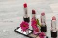 Multicolored lipstick on a white surface. Cosmetic set on light dressing table.