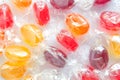 Multicolored lollipops candy in transparent packaging background
