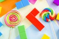 Multicolored lollipops and puzzle cubes; game and candies Royalty Free Stock Photo