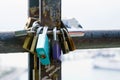 Multicolored love locks, locked on a rusty pipe. Symbol of love and loyalty