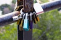 Multicolored love locks, locked on a rusty pipe. Symbol of love and loyalty