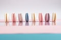 Multicolored macarons on a white, pink, blue background Royalty Free Stock Photo