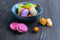 Multicolored macaroon cookies in a blue ceramic bowl Royalty Free Stock Photo