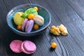 Multicolored macaroon cookies in a blue ceramic bowl Royalty Free Stock Photo