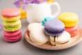 Multicolored macaroons with spring snowdrop crocus flowers and cup of coffee on gray pastel background. side view, close up, Royalty Free Stock Photo