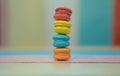 Multicolored macaroons on white wooden background