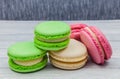 Multicolored macaroons on a wooden table, on a dark blue background Royalty Free Stock Photo