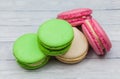 Multicolored macaroons on a wooden table, on a dark blue background, top view Royalty Free Stock Photo