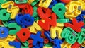 Multicolored magnetic fridge letters of the alphabet mixed up