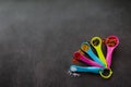 Multicolored measuring spoons with spices: chili flakes, a mix of pepper peas, curry, paprika and coarse sea salt. Black chalk Royalty Free Stock Photo