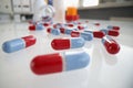 Multicolored medical pills are scattered on table closeup