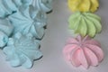 Multicolored meringue pieces on a white background