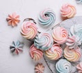 Multicolored meringue on wooden tray top view