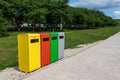 Multicolored metal containers for separate garbage collection in a public park. Environmental conservation, landscaping Royalty Free Stock Photo