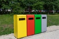 Multicolored metal containers for separate garbage collection in a public park. Environmental conservation, landscaping Royalty Free Stock Photo