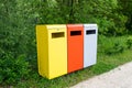 Multicolored metal containers for separate garbage collection in a public park. Environmental conservation, landscaping Royalty Free Stock Photo