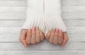 Multicolored modern manicure, nail design, summer mood, hands in a white sweater top view