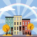 Multicolored multi-party houses in the center of rays and under the rainbow. Flat cartoon vector illustration of Autumn city