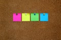 Multicolored notes for messages and reminders on cork board