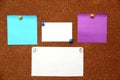 Multicolored notes for messages and reminders on cork board