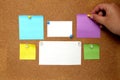 Multicolored notes for messages and reminders on cork board
