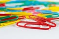 Multicolored office paperclips on white desktop closeup Royalty Free Stock Photo