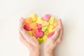 Multicolored origami paper hearts in female hands. Women hands holding many bright heart. Love, romance, dating Royalty Free Stock Photo