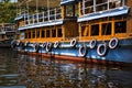 Multicolored painted old car tires hang over the side of a pleasure boat. Royalty Free Stock Photo