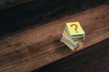 Multicolored paper with QUESTION MARK on a wooden table background