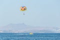 Multicolored parasail wing pulled by a boat. Royalty Free Stock Photo