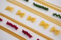 Multicolored pasta arranged on white background Royalty Free Stock Photo