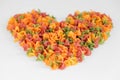 Multicolored pasta scattered on a white background in the shape of a heart. Top view. Copy, empty space for text Royalty Free Stock Photo
