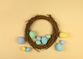 Multicolored pastel decorative Easter eggs and willow wreath. Happy Easter card